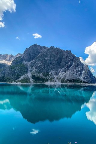 Обои озеро, горы, отражение, австрия, альпы, lünersee, lüner lake, озеро люнерзе, lake, mountains, reflection, austria, alps разрешение 2112x1188 Загрузить